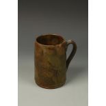 A DARK GLAZED STONEWARE MUG, Staffordshire or Nottinghamshire, late 18th/early 19th century, 6.75"