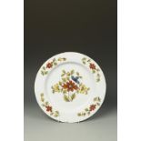 A DELFT CHARGER, decorated in the 'Fazackerly' palette with floral sprays in red, green, blue and