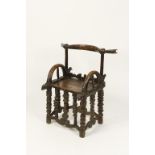 TRIBAL ART: AN AFRICAN CHAIR of unusual form with curved back, arms and turned legs with all over