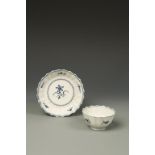 A WORCESTER BLUE AND WHITE PORCELAIN TEA BOWL AND SAUCER, 'Narcissus' pattern with fluted body and