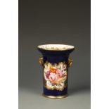 A COALPORT PORCELAIN CYLINDRICAL SPILL VASE, with flared rim and two gilt eagle mask ring handles,