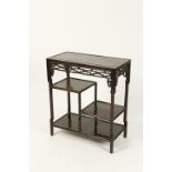 A CHINESE HARDWOOD SIDE TABLE, the rectangular top above asymmetric shelves with pierced and