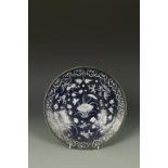 A CHINESE SLIP-DECORATED BLUE-GLAZED DISH decorated with flowers, Qing, 19thC, 11.5" dia.