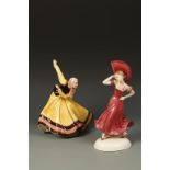KATZHUTTE: A MODEL OF A WOMAN DANCING with a fan decorated in rose pink, on an oval white base,