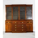 A GEORGE III STYLE MAHOGANY BREAKFRONT SECRETAIRE LIBRARY BOOKCASE with glazed cupboards above