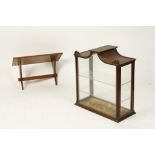 A MAHOGANY WALL MOUNTED DISPLAY CABINET with arched top and carved uprights, 26" wide, with