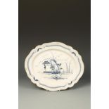 AN ENGLISH PORCELAIN LOBED OVAL DISH, painted in blue with a fisherman in a Chinese river landscape,