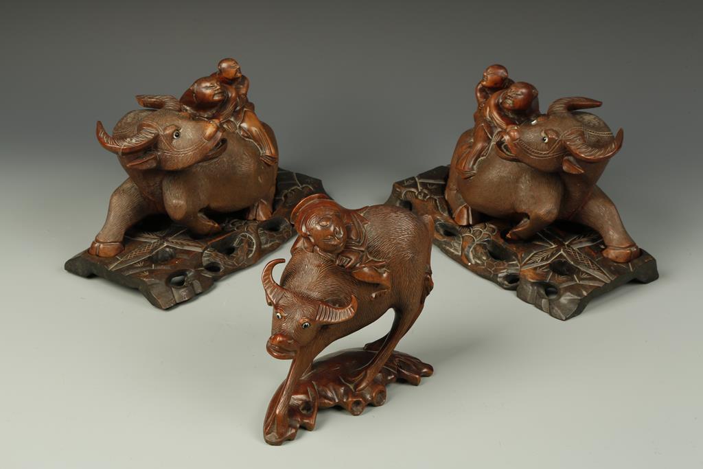 A PAIR OF CHINESE 'BOY AND BUFFALO' CARVINGS, each on hardwood stands, late Qing/early Republic,