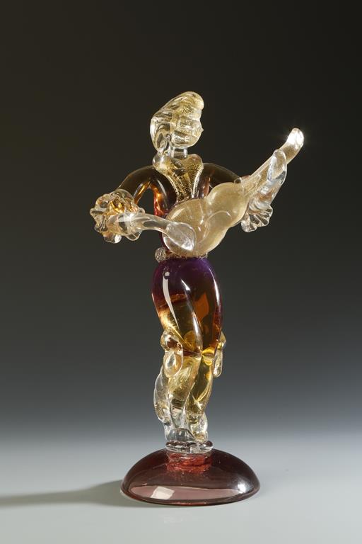 ALFREDO BARBINI: A RED, GOLD AND CLEAR GLASS SCULPTURE OF A MAN PLAYING A GUITAR, with engraved