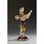 ALFREDO BARBINI: A RED, GOLD AND CLEAR GLASS SCULPTURE OF A MAN PLAYING A GUITAR, with engraved