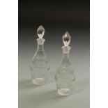 A PAIR OF GEORGE III SMALL OVOID DECANTERS, and faceted stoppers, topped with diamond and facet