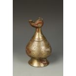 AN ISLAMIC METALWORK OIL LAMP, probably Iranian, with engraved decoration, 9" high