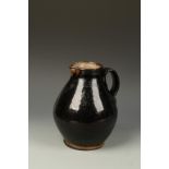 A SLIPWARE BROAD FLAGON, with burnished body, possibly German, late 18th/early 19th century, 10"