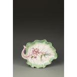 A CHELSEA PORCELAIN CABBAGE LEAF SHAPED DISH, painted with a flower spray and with puce veining,