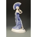 KATZHUTTE: A LARGE FIGURE OF AN ART DECO WOMAN dancing with an open fan, decorated in blue with