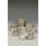 EIGHT BURMESE SILVER CYLINDRICAL BOXES, with relief foliate decoration, the largest 3.5" dia (8)