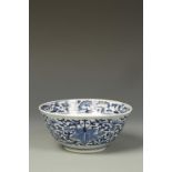 A CHINESE BLUE AND WHITE BOWL, decorated with flowerheads and tendrils, Qing, 19thC, 6" dia.