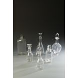 A COLLECTION OF SIX CLEAR GLASS DECANTERS