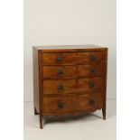 A REGENCY MAHOGANY BOW FRONT CHEST OF DRAWERS with spiral-turned column corners, 37" wide