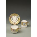 A COALPORT PORCELAIN TEA CUP, COFFEE CAN AND SAUCER, 'Church Gresley' pattern on a yellow ground