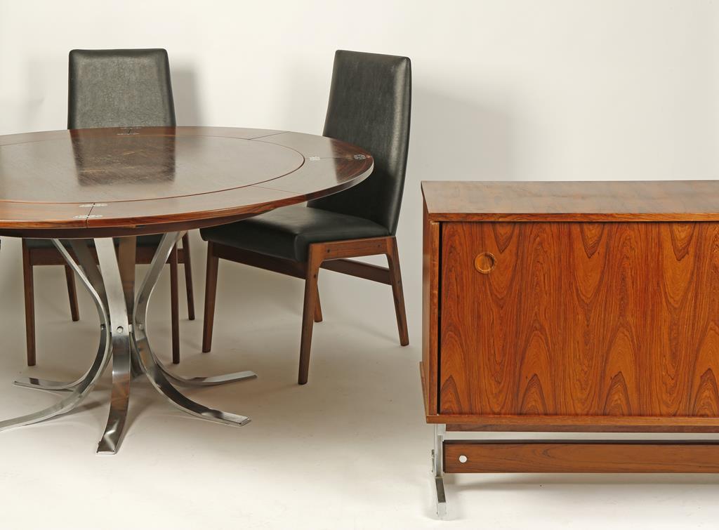 A DANISH "DYRLUND" DINING SUITE comprising an extending circular table with "flip-flap" extensions