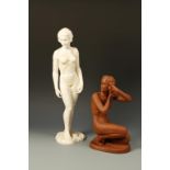 KATZHUTTE: AN UNGLAZED TERRACOTTA FIGURE OF A CROUCHING NUDE, arranging her hair, on an oval base,