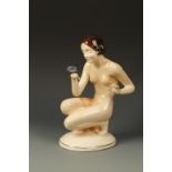 HERTWIG KATZHUTTE: AN EARTHENWARE MODEL OF A CROUCHING NUDE, observing a butterfly on her hand,