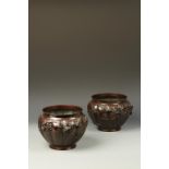 A PAIR OF JAPANESE BRONZE CENSERS decorated in relief with birds, Meiji, 9" dia. (2)