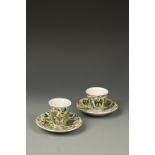 A PAIR OF TURKISH POLYCHROME CUPS AND SAUCERS, decorated with flowers, the saucers 5" dia. (2)