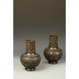 A PAIR OF JAPANESE BRONZE VASES with relief bands of decoration, Meiji, 9.75" high (2)