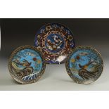 A PAIR OF JAPANESE CLOISONNE DISHES, decorated with birds in landscapes, Meiji, 12" dia.; and