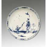 A WORCESTER SAUCER, painted in blue in Chinese style with 'Walk in the Garden' pattern, crossed