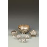 FIVE BURMESE SILVER CYLINDRICAL BOXES AND A BOWL, with relief decoration, the bowl 6" dia (6)