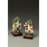 A PAIR OF STAFFORDSHIRE FIGURE GROUPS, children playing beside trees, 19th century, 8" high