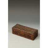 A CHINESE RECTANGULAR WOOD BOX carved with figures in a woodland, late Qing, 9.75" long