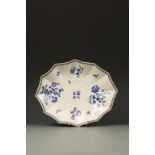 A WORCESTER PORCELAIN DISH, twelve sided and painted in dry blue with flowers and leaves, within a