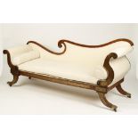 A REGENCY ROSEWOOD EFFECT BRASS INLAID CHAISE LONGUE with scrolling ends, splayed legs and brass
