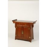 A CHINESE HARDWOOD ALTAR COFFER with scroll-end top above two drawers and cupboards with carved