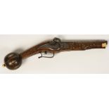 A EUROPEAN PISTOL, with engraved steel furniture, decorated with a soldier and flora, the wood