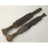 A PAIR OF AFRICAN CARVED WOOD CLUBS OR POSTS, with geometric carved decoration, 30.5" wide