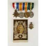 A GREAT WAR TRIO AND TERRITORIAL MEDAL GROUP, with badge and a photographic postcard, 1914-15