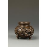 A SMALL CHINESE BRONZE TRIPOD WATER POT, of rounded form, with relief dragon decoration, late Ming