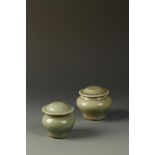 TWO SIMILAR CHINESE LONGUAN CELADON JARLETS of baluster form with covers, Yuan - Ming Dynasty, 6.8cm