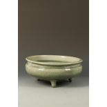 A CHINESE LONGQUAN CELADON TRIPOD CENSER with a waisted neck above the rounded body with cross-