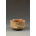 A JAPANESE RAKU TEA BOWL inscribed on the body Kenzan (probably Tominosuke Miyazaki fl. 1770-