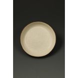 A FINE CHINESE DINGYAO SHALLOW WASHER, the centre carved with a peony flower and foliage, the