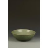 A LARGE CHINESE LONGQUAN CELADON BOWL of gently rounded form, the central well moulded with a