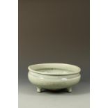 A CHINESE LONGQUAN CELADON TRIPOD CENSER with a waisted neck above the rounded body with cross-