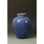 A LARGE CHINESE BLUE-GLAZED OVOID VASE with moulded decoration, one side showing flowers amongst