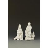 TWO CHINESE DEHUA GUANYIN FIGURES, the larger example with a child attendant, Qing Dynasty, 17th/